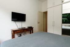 Bedroom with double bed, wardrobe and TV.