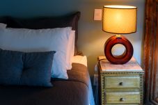 Bedroom with double bed and lamp.