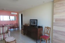 Large, well-lit and comfortable living room. Equipped with sofa, TV and dining table.